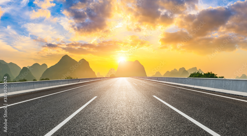 Country asphalt road and green mountain natural scenery in Guilin at sunrise,China.