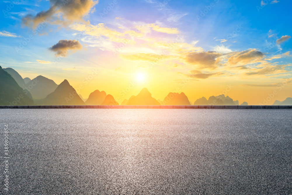 Country asphalt road and green mountain natural scenery in Guilin at sunrise,China.