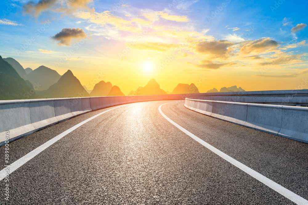 Country asphalt road and green mountain natural scenery in Guilin at sunrise,China.