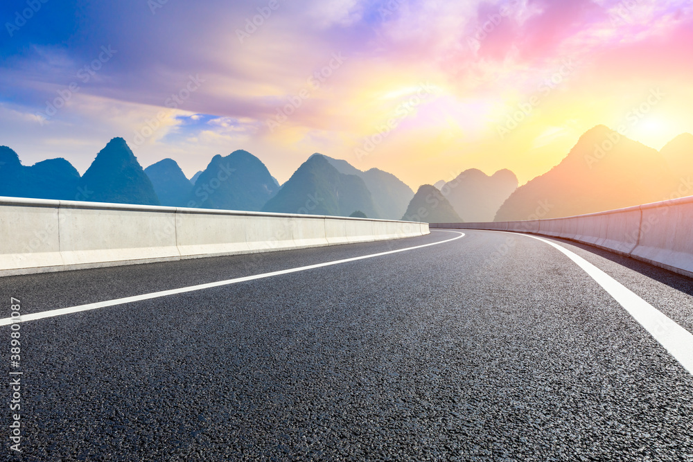 Country asphalt road and green mountain natural scenery in Guilin at sunrise,China.