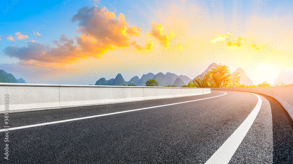 Country asphalt road and green mountain natural scenery in Guilin at sunrise,China.