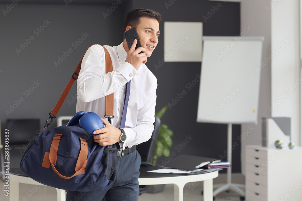 Young businessman going to go to boxing training after working day in office