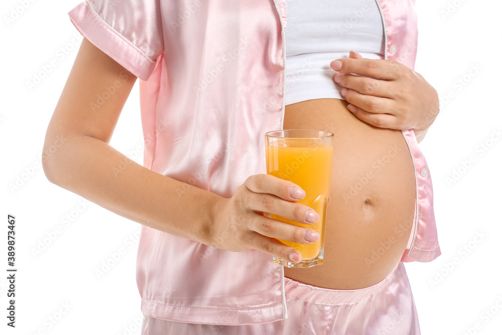 Beautiful pregnant woman with glass of juice on white background, closeup