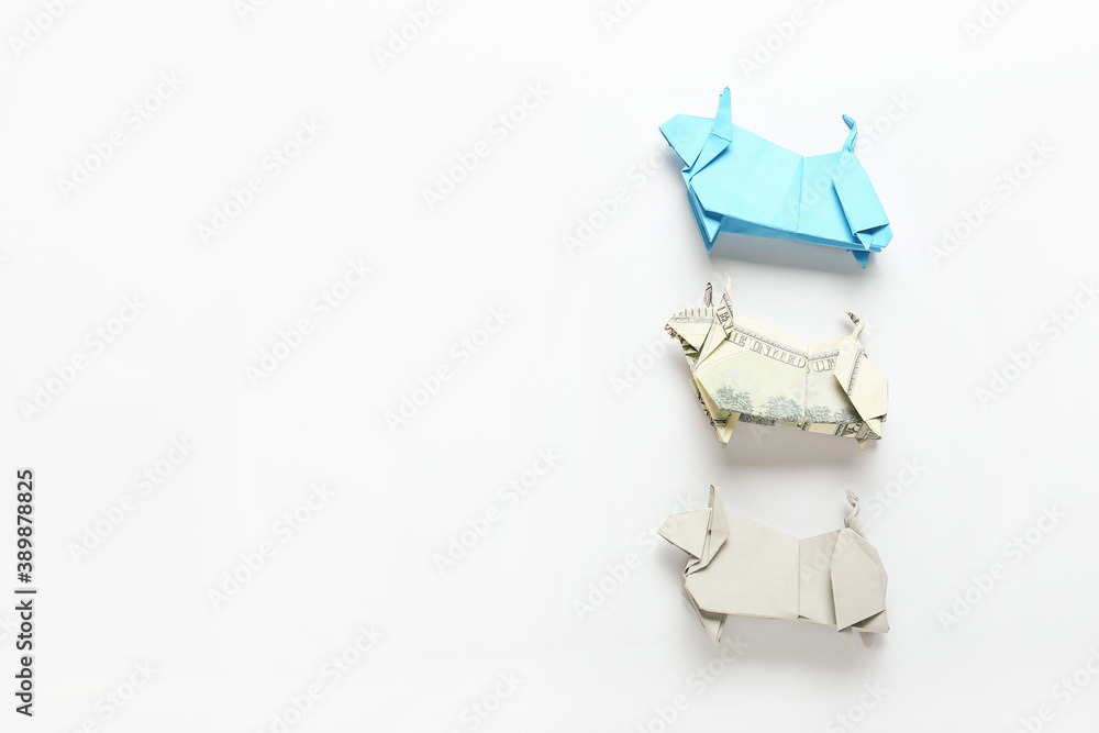 Origami bulls as symbol of year 2021 on white background