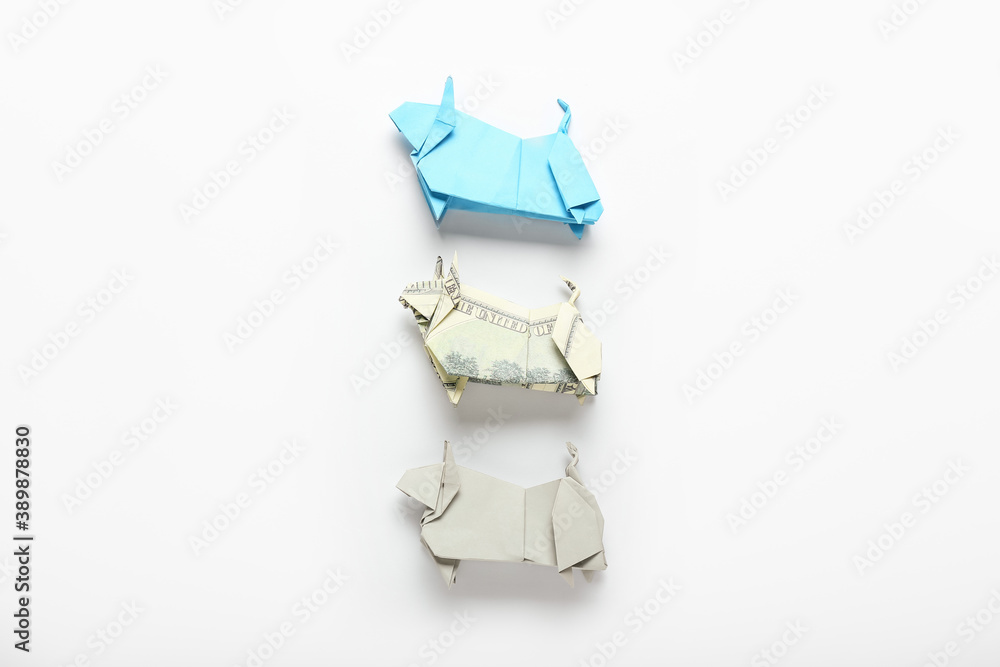 Origami bulls as symbol of year 2021 on white background