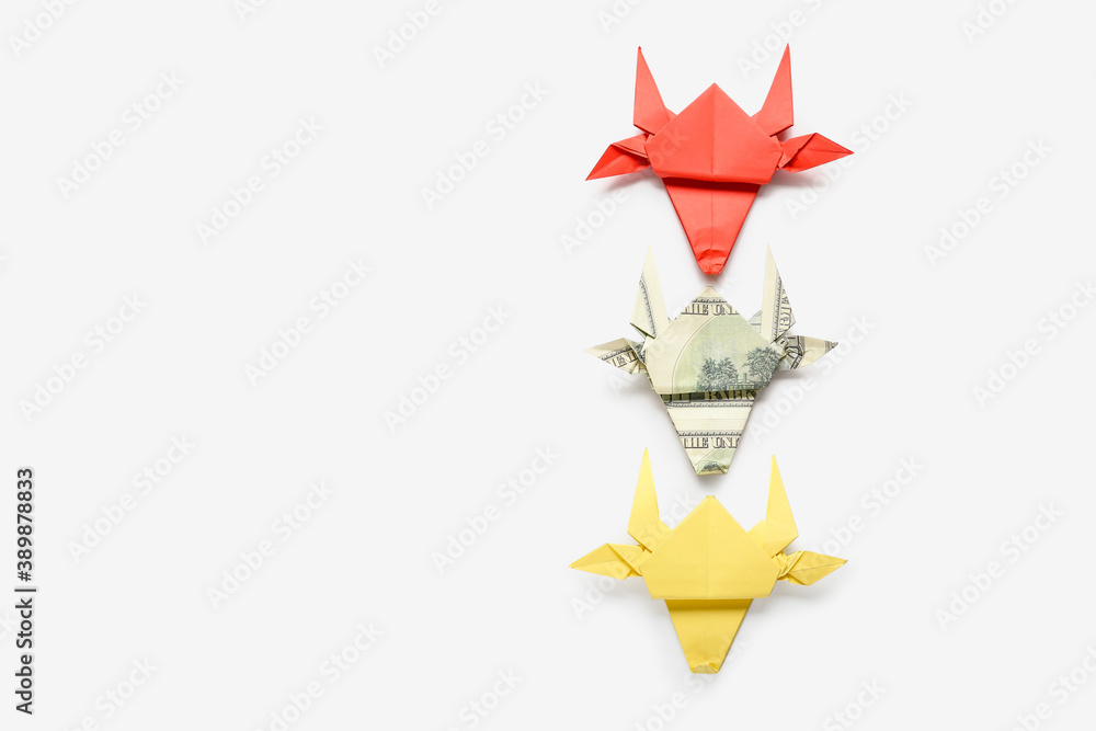 Origami bulls as symbol of year 2021 on white background