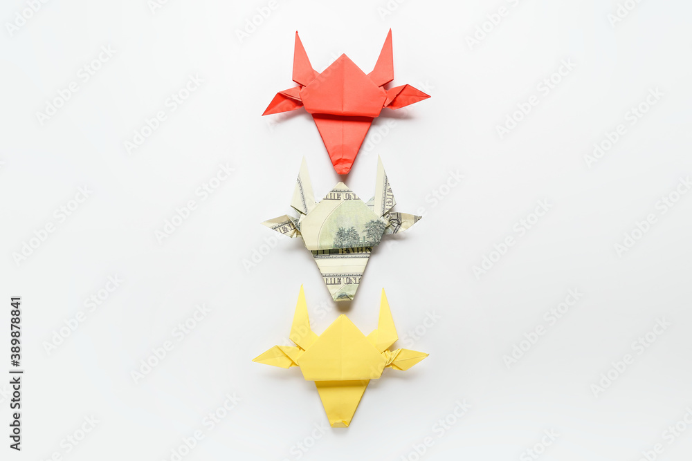 Origami bulls as symbol of year 2021 on white background