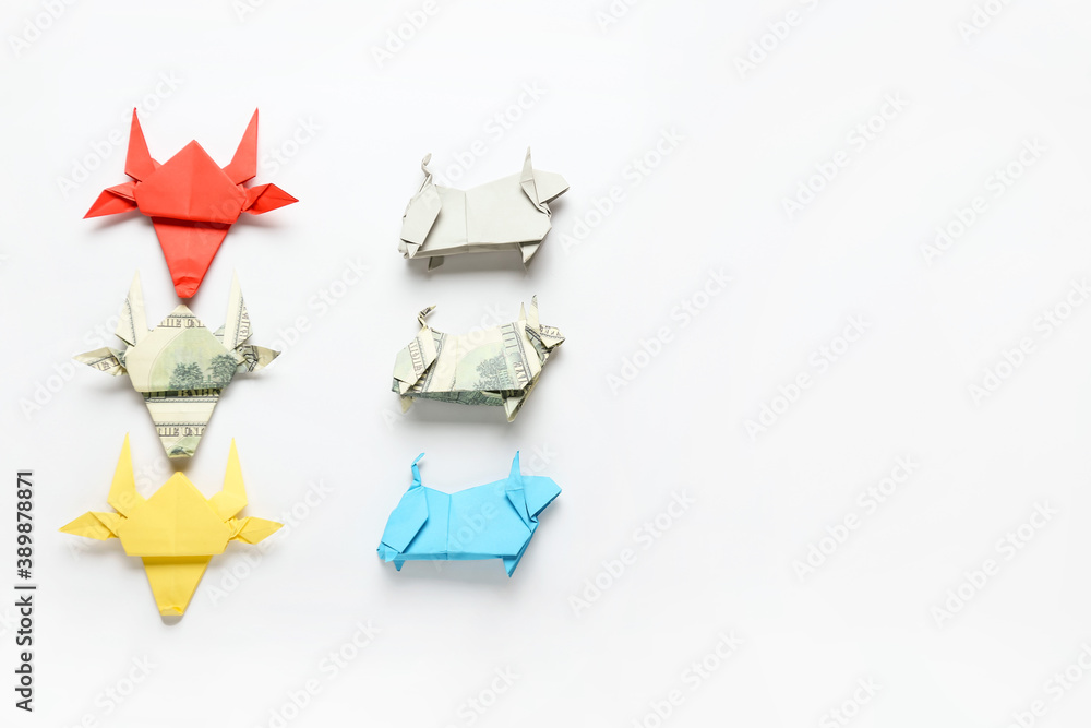 Origami bulls as symbol of year 2021 on white background