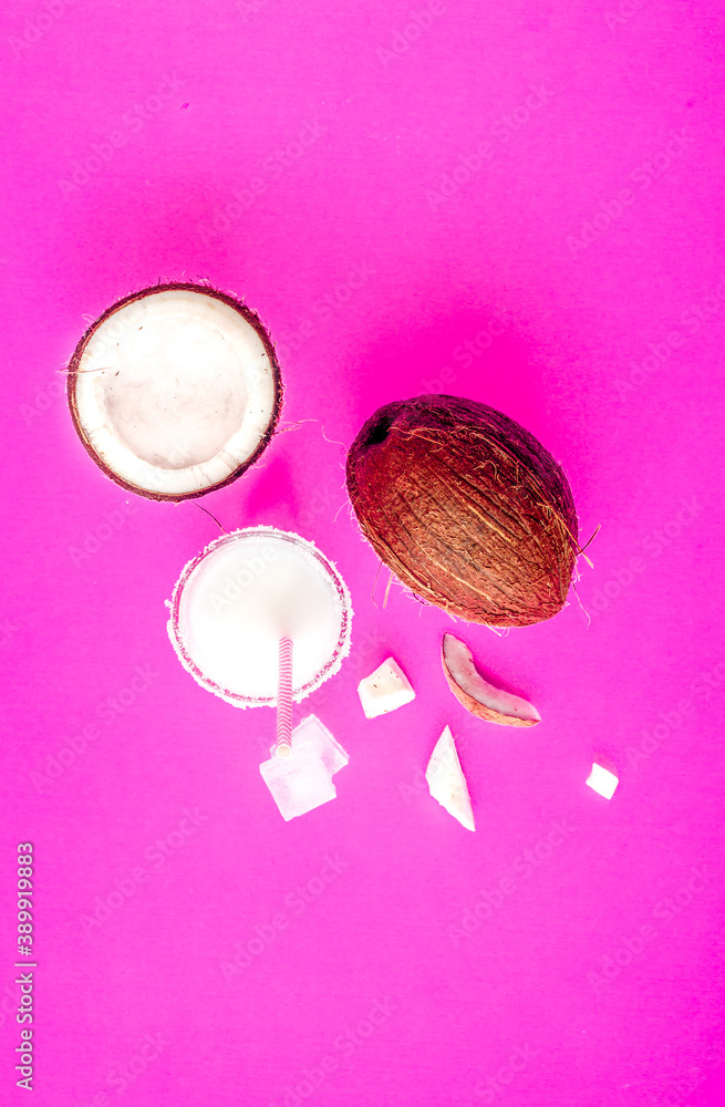 cocktail with coconut on purple background top view