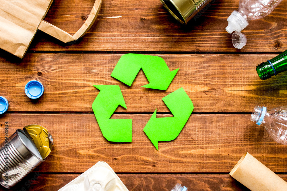 environment concept with recycling symbol on wooden background top view