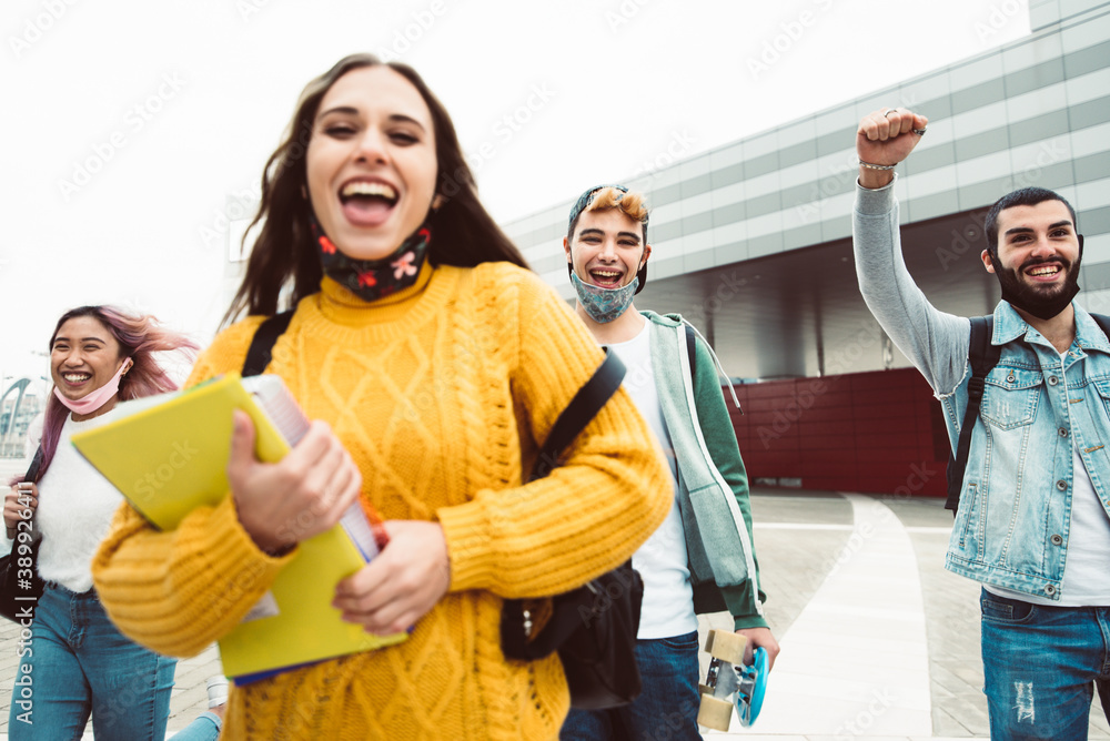 Multiracial students walking on city street.- New normal lifestyle concept with friends wearing face