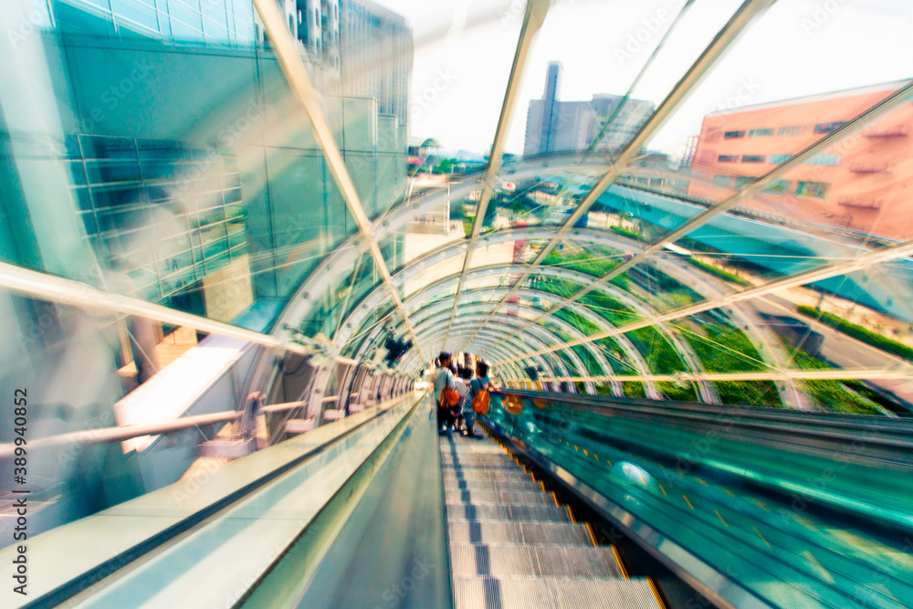 Abstract motion blurred view through an escalator tunnel