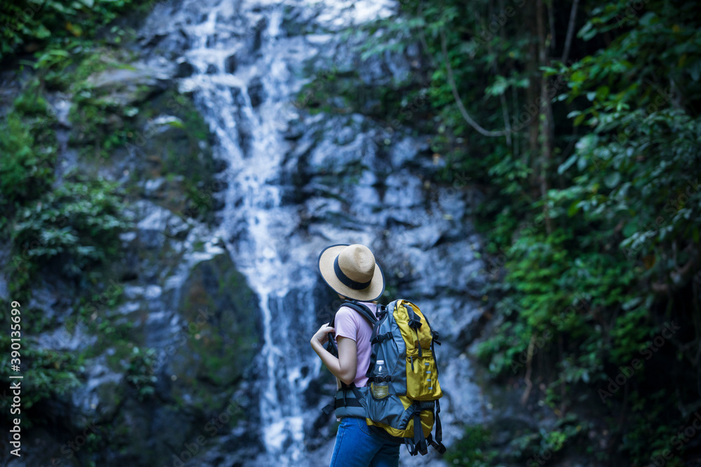 women in nature, backpackers,Women with backpackers enjoy waterfalls,  nature tourism concept.