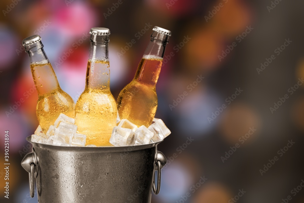 Bottles of cold and fresh beer with ice in the bucket