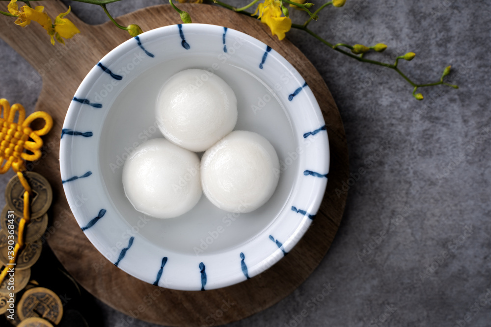 Top view of big tangyuan yuanxiao in a bowl on gray background for lunar new year food.