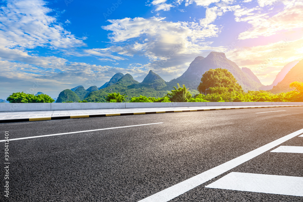 Empty asphalt highway and green mountain natural scenery in Guilin at sunrise,China.