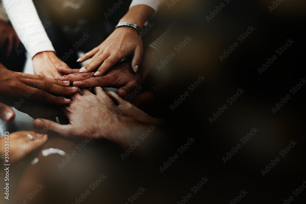 Business people stacking their hands