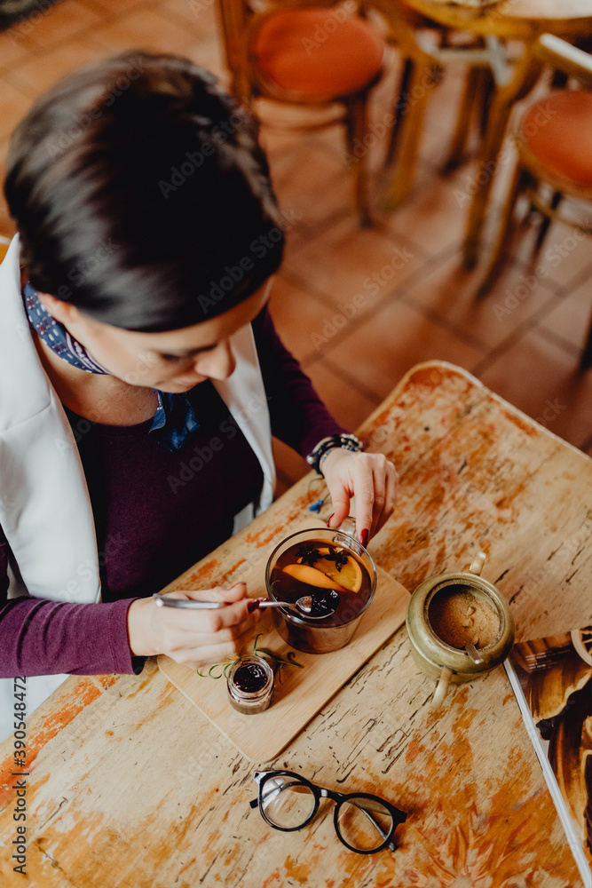 Woman relaxing with a cup of Mulled wine