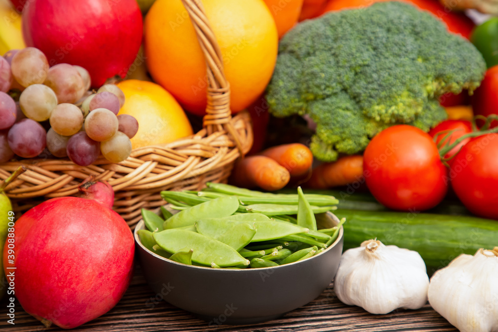 Group vegetables and Fruits Apples, grapes, oranges, and bananas in the wooden basket with carrots, 