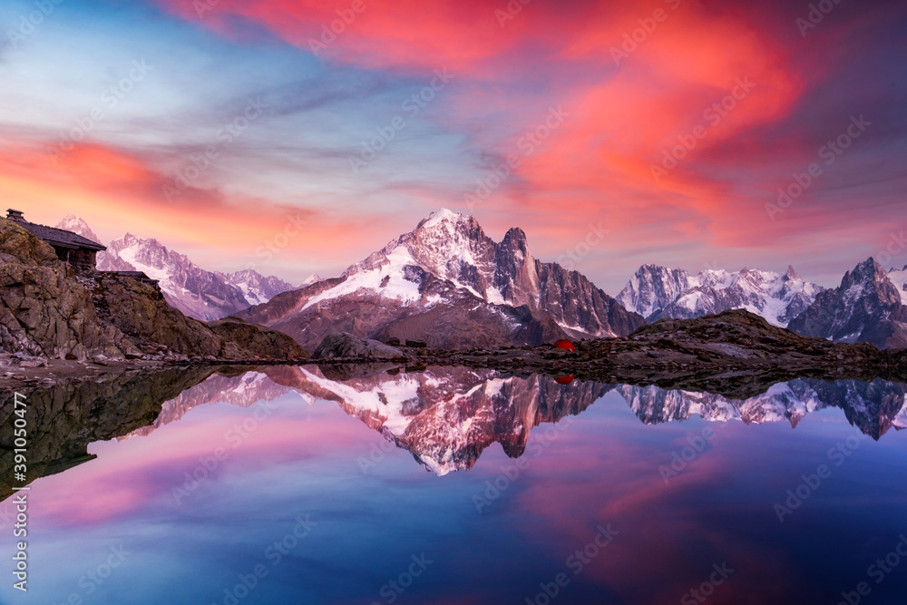 Sunset on lake Lac Blanc in France Alps. Monte Bianco mountains range glowing by sunset light on bac