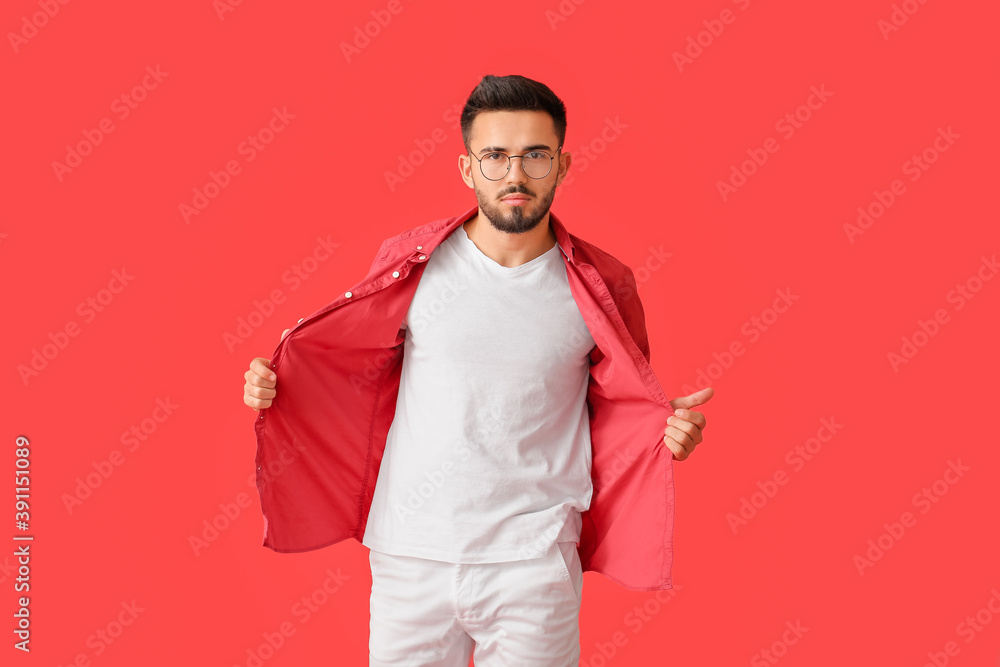 Fashionable young man on color background