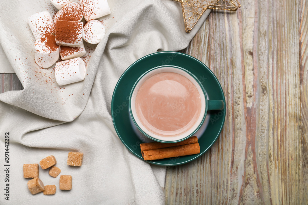 Cup of hot cacao drink with marshmallows on table