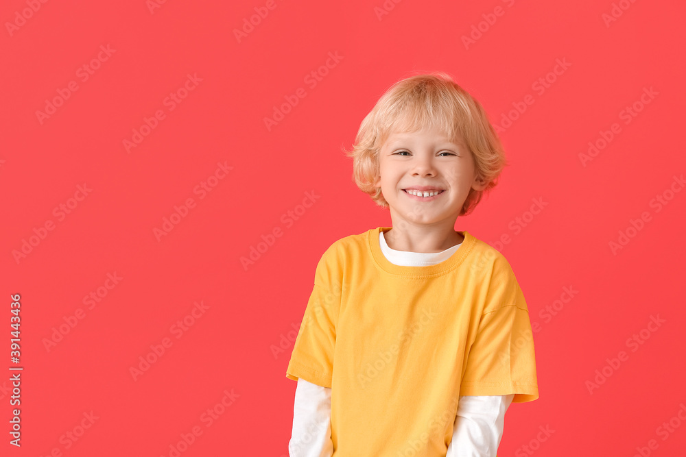 Cute little boy on color background