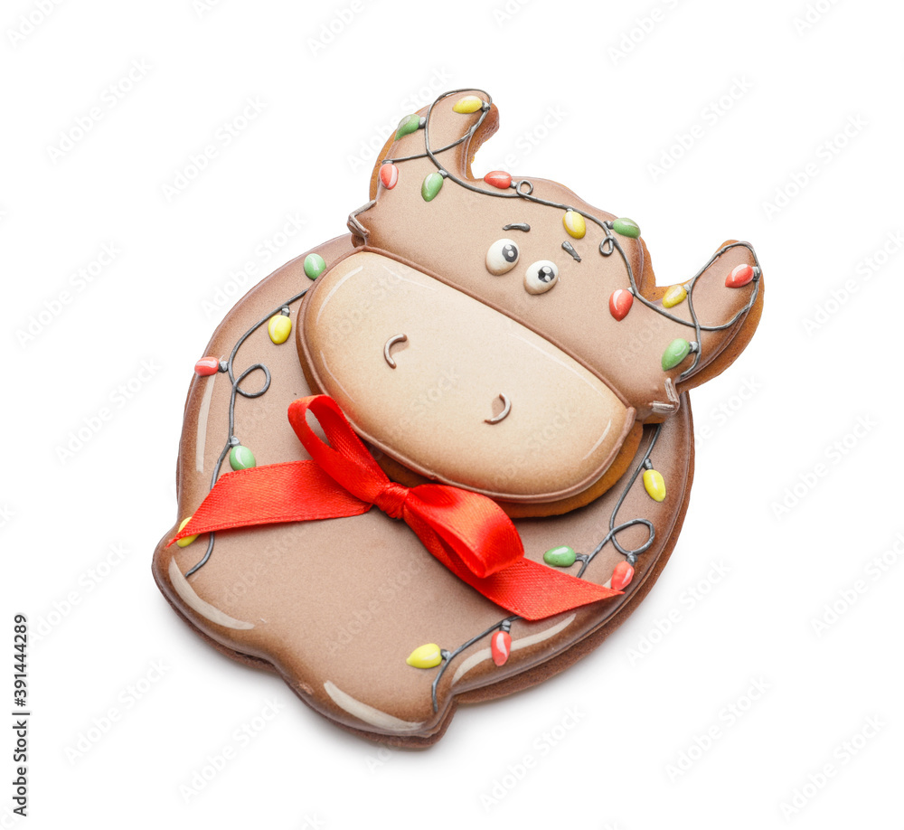 Tasty Christmas cookie in shape of bull on white background