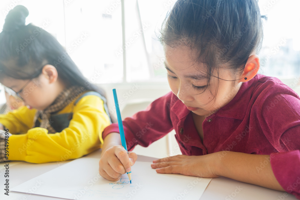 The little girl is intently doing her homework
