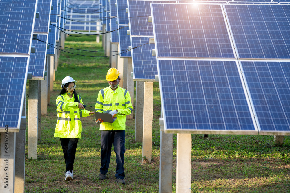 Engineers with architects examining solar power plant,Solar station development concept.