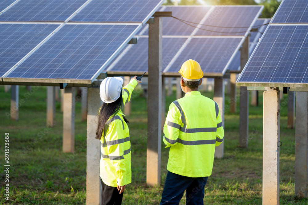 Engineers with architects examining solar power plant,Solar station development concept.