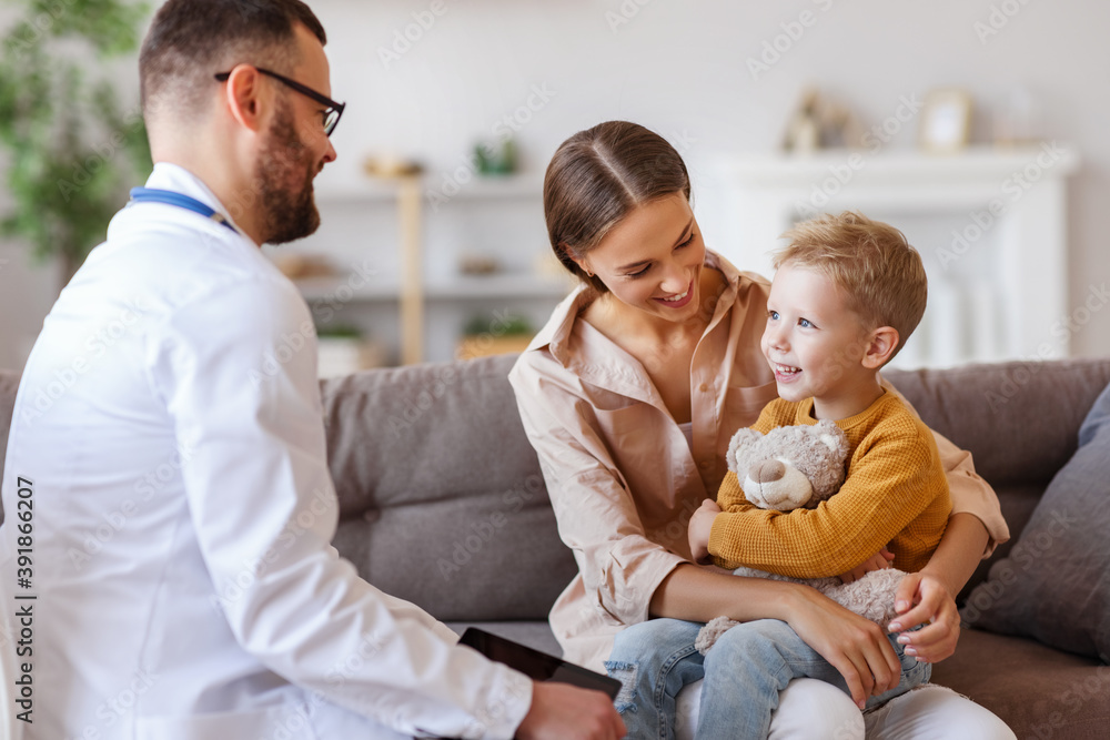 happy child boy patient with his mother at reception of a friendly pediatrician family doctor family