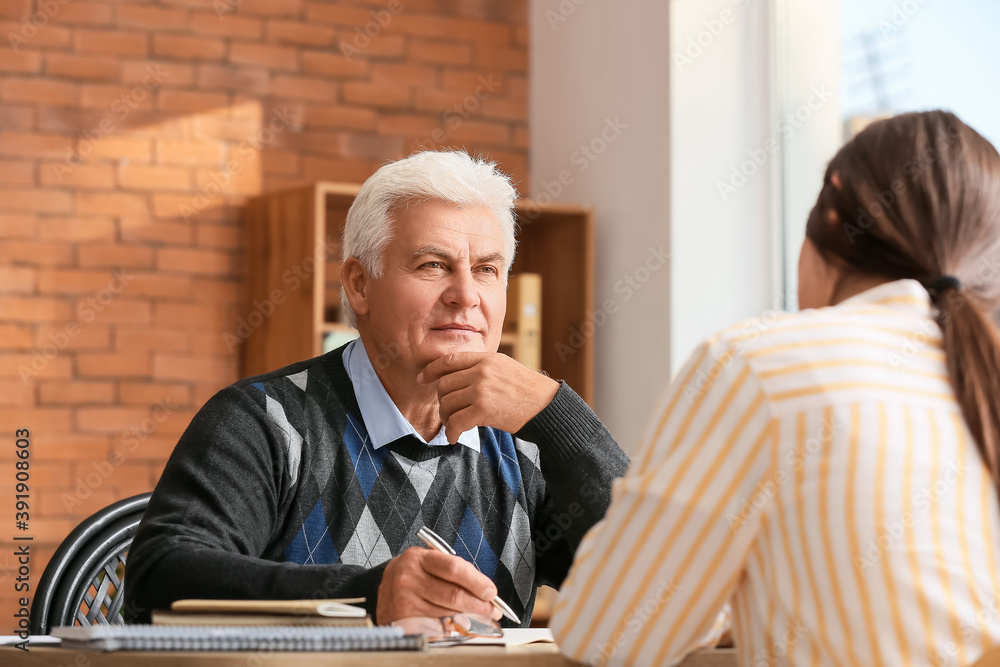 Senior male psychologist working with patient in office