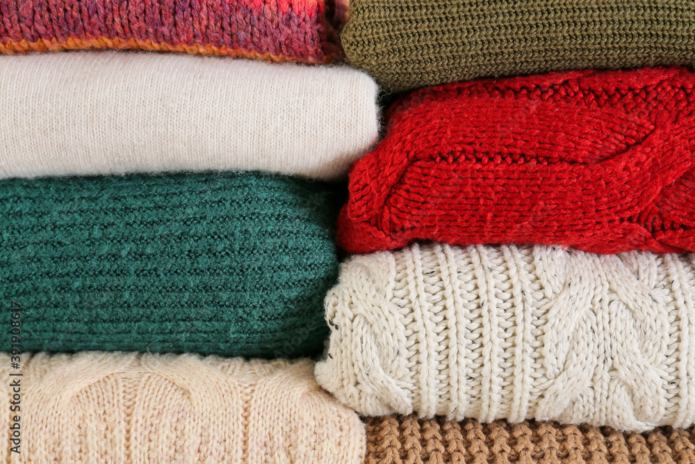 Stack of warm winter clothes as background