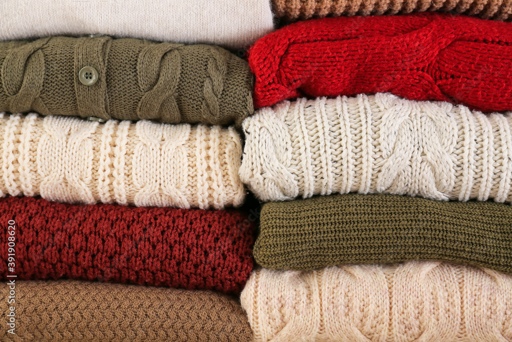 Stack of warm winter clothes as background