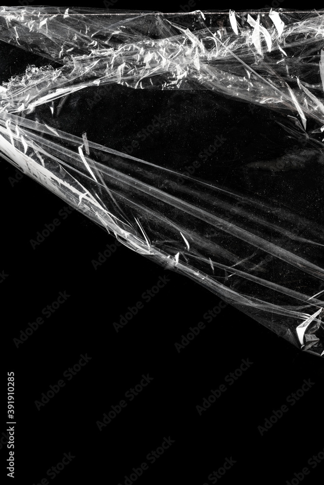 Wrinkled plastic wrap texture on a black background