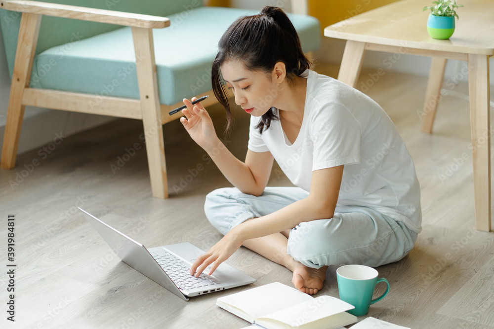 
student girl studying at home with typing pen