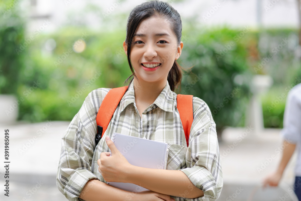 女学生高兴地把她的书带到了学校