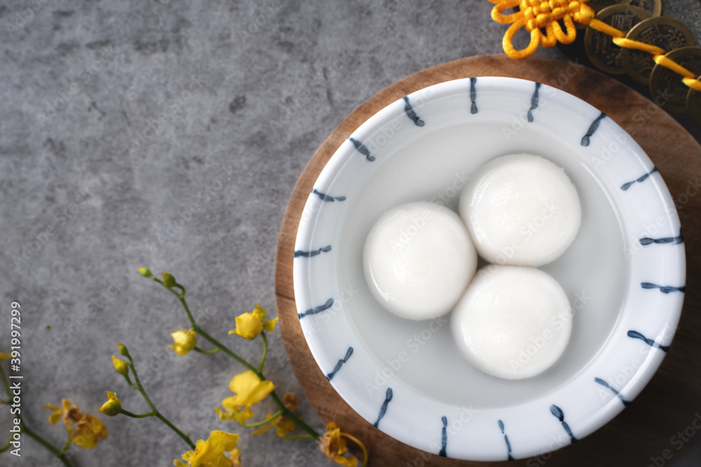 Top view of big tangyuan yuanxiao in a bowl on gray background for lunar new year food.