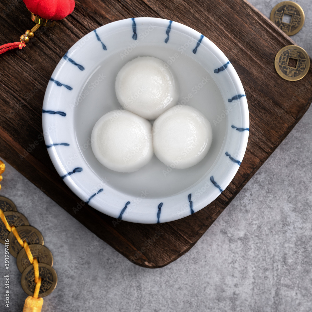 Top view of big tangyuan yuanxiao in a bowl on gray background for lunar new year food.