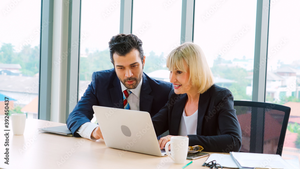 Two business people talk project strategy at office meeting room. Businessman discuss project planni