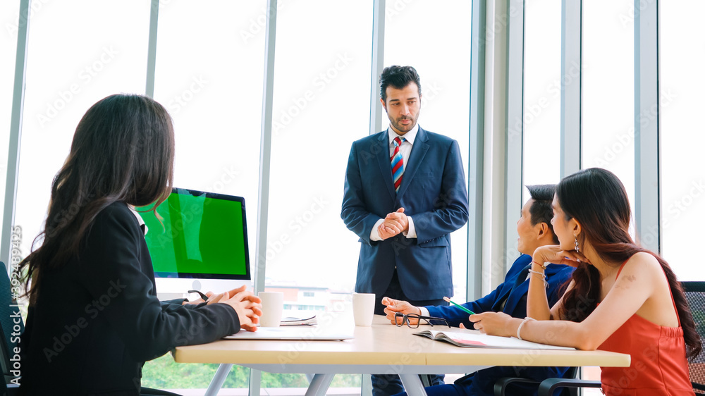 Business people in the conference room with green screen chroma key TV or computer on the office tab