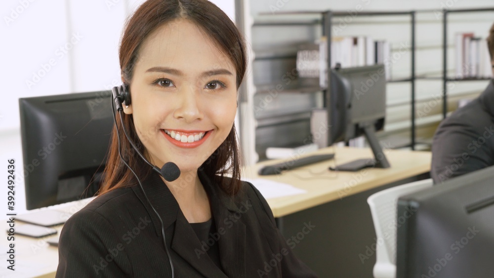 Business people wearing headset working in office to support remote customer or colleague. Call cent