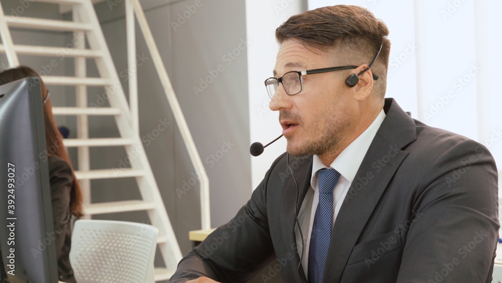 Business people wearing headset working in office to support remote customer or colleague. Call cent