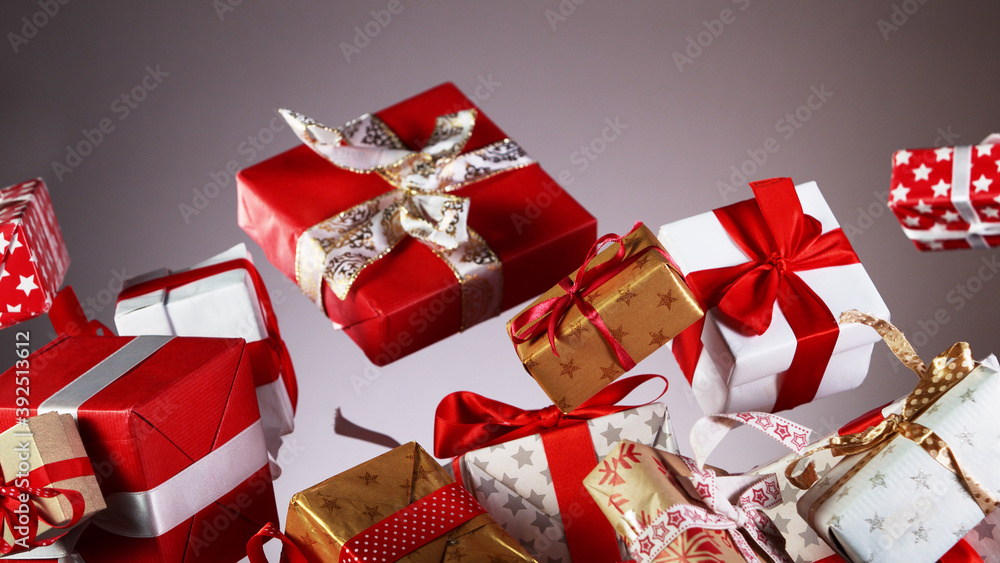 Flying christmas gifts on coloured background