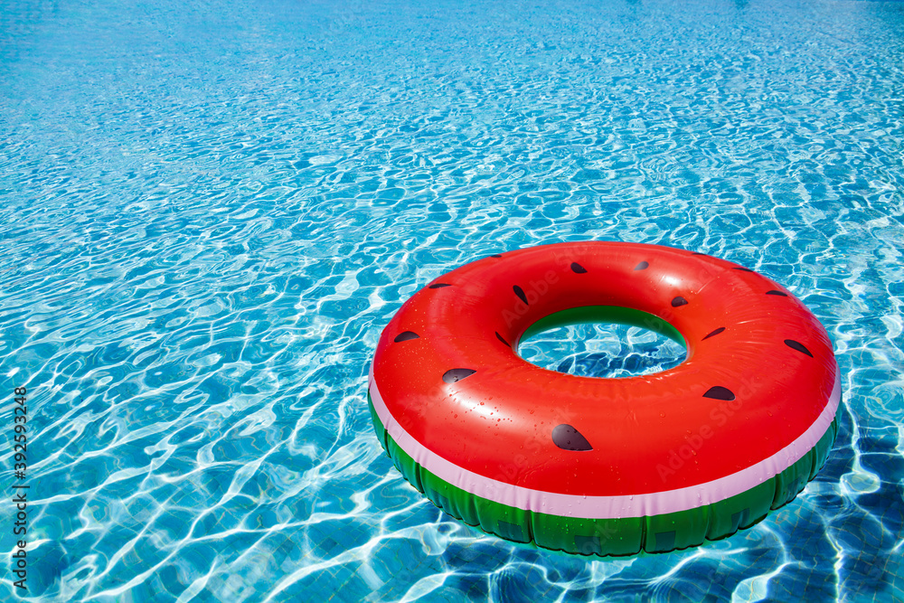 Inflatable watermelon buoy swim in the swimming pool view with perspective