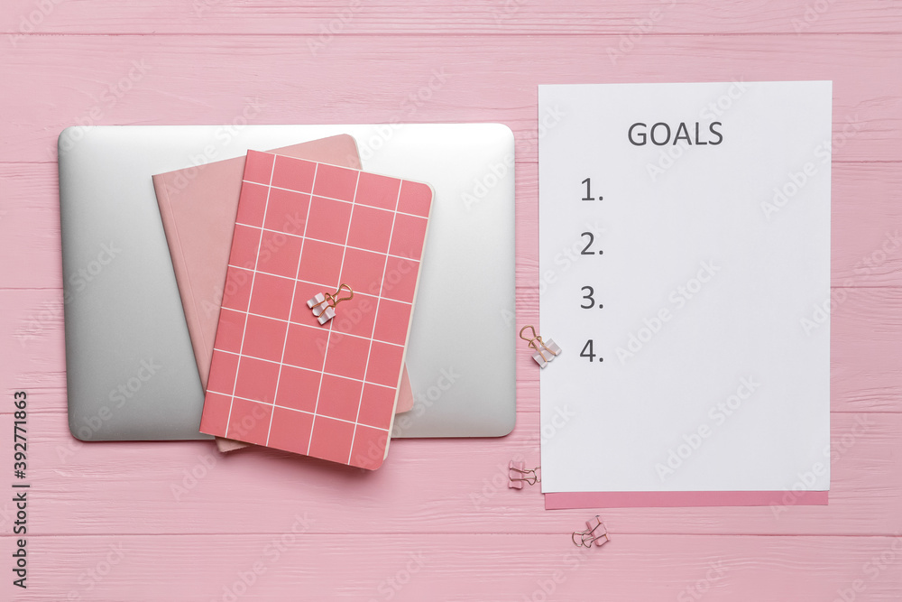 Empty to do list with laptop and stationery on color wooden background