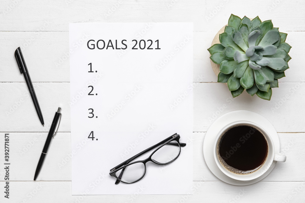 Empty to do list on 2021 year with cup of coffee on white wooden background