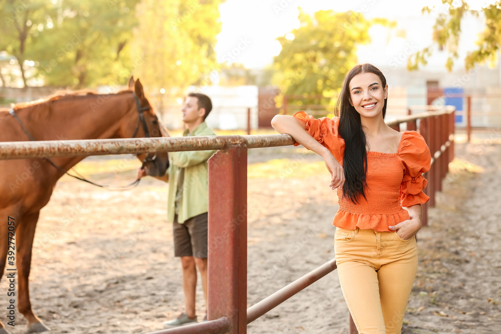 Young couple with cute horse outdoors