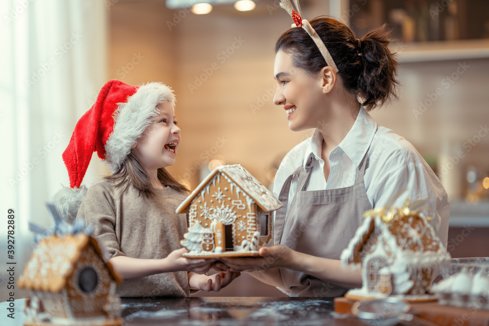 Family cooking gingerbread house